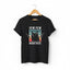 A black short-sleeve crewneck t-shirt with a graphic print of a black cat holding two pistols, set against a retro sunset background with the text 'PEW PEW MADAFAKAS'.
