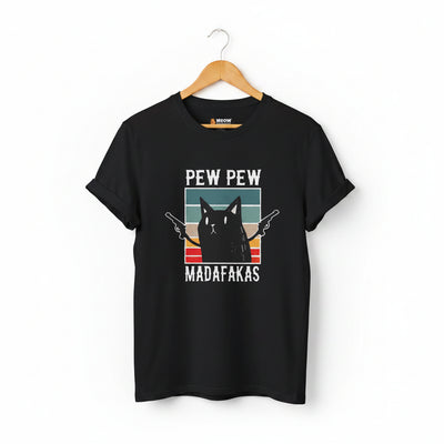 A black short-sleeve crewneck t-shirt with a graphic print of a black cat holding two pistols, set against a retro sunset background with the text 'PEW PEW MADAFAKAS'.