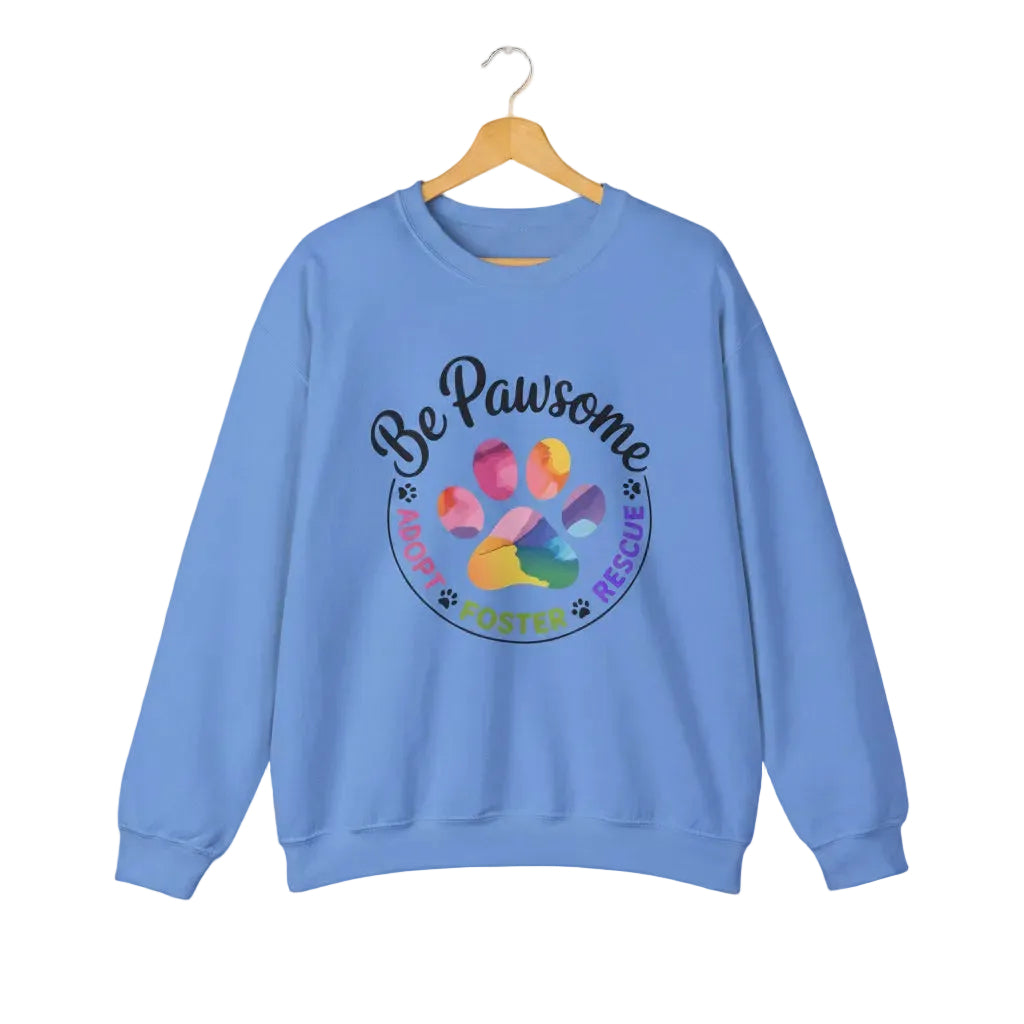Carolina blue crewneck sweatshirt featuring a colorful paw print for cat rescue advocates with text 'Be Pawsome Adopt Foster Rescue'.