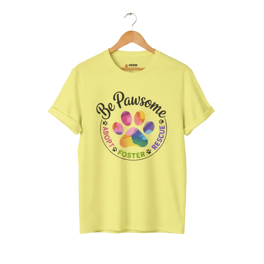 Cornsilk cat rescue t-shirt featuring a rainbow paw print graphic with text 'Be Pawsome Adopt Foster Rescue'.