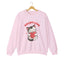 A light pink crewneck sweatshirt featuring a cartoon graphic of a gray tabby cat holding a red heart, with the text 'ADOPT LOVE' printed above it in white for cat lovers.