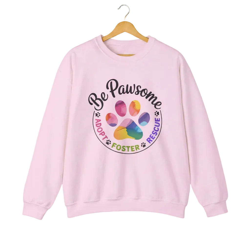 Light pink crewneck sweatshirt featuring a colorful paw print for cat rescue advocates with text 'Be Pawsome Adopt Foster Rescue'.