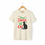 Natural short-sleeve t-shirt on a wooden hanger with green and red text saying "Dear Santa, it was the Cat" featuring a black cat silhouette.