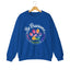 Royal blue crewneck sweatshirt featuring a colorful paw print for cat rescue advocates with text 'Be Pawsome Adopt Foster Rescue'.