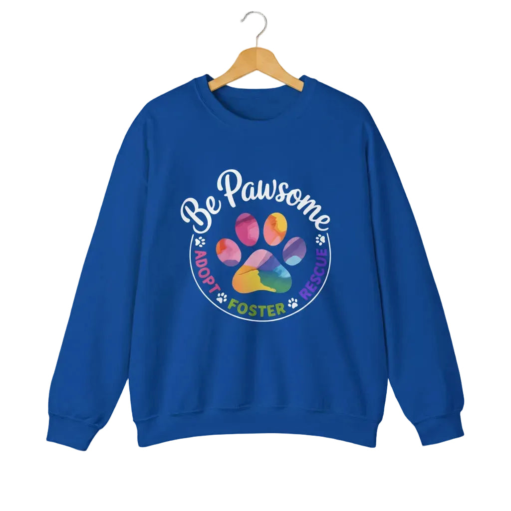 Royal blue crewneck sweatshirt featuring a colorful paw print for cat rescue advocates with text 'Be Pawsome Adopt Foster Rescue'.