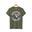Military green unisex short-sleeve t-shirt with a graphic of a cartoon cat holding an American flag and the text 'STARS, STRIPES & SCRATCHES'.