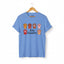 Carolina blue Stay Pawsitive t-shirt with colorful cat paws illustration for cat lovers.