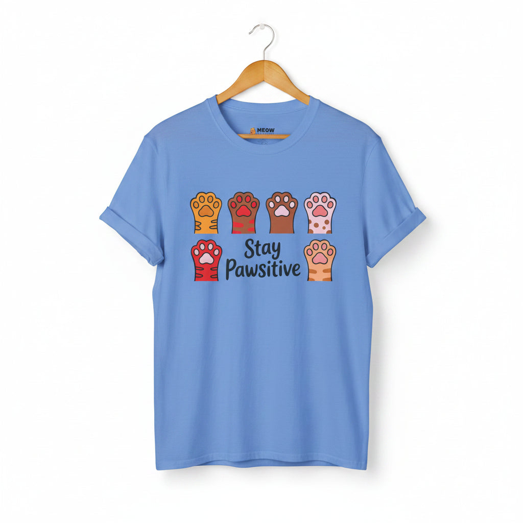 Carolina blue Stay Pawsitive t-shirt with colorful cat paws illustration for cat lovers.