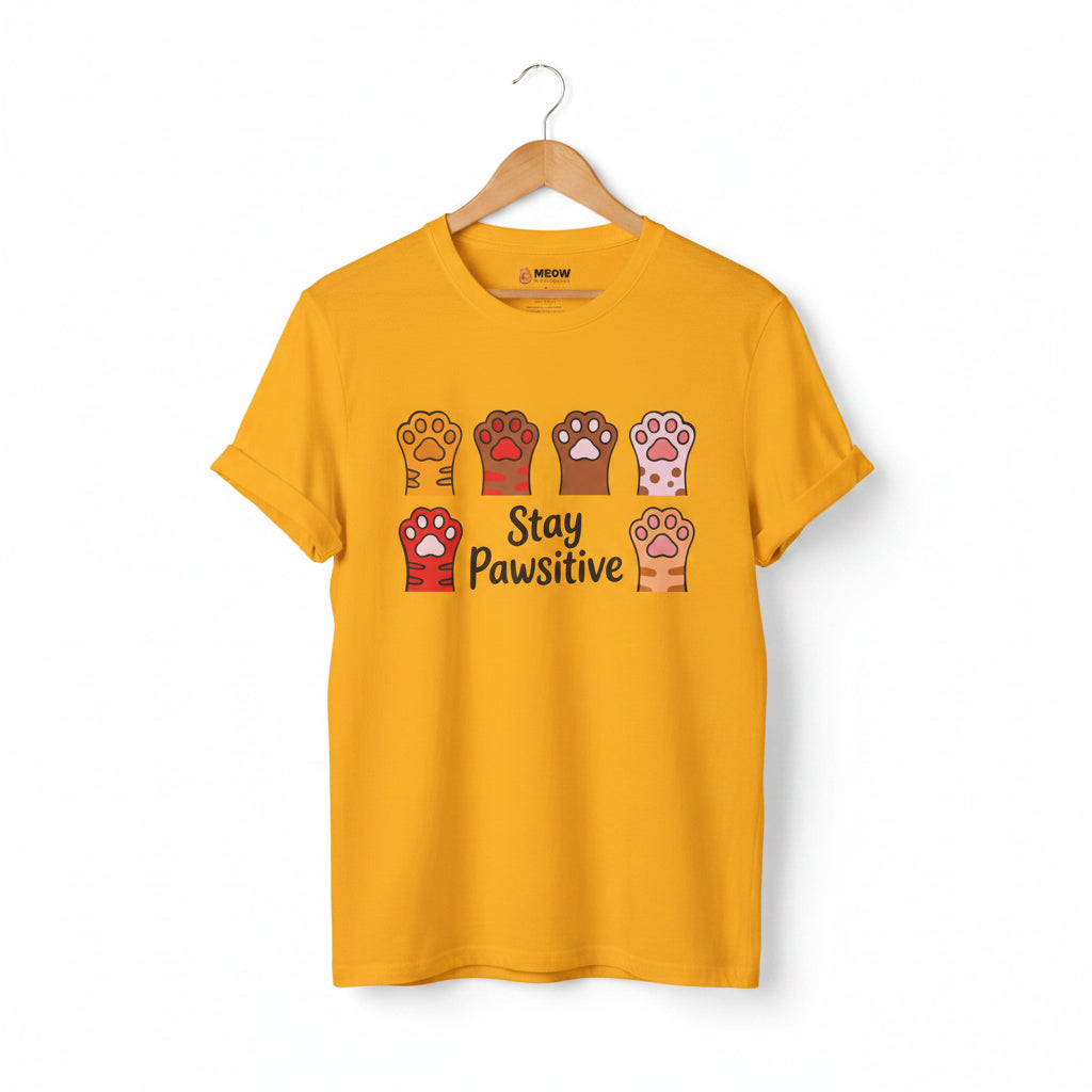 Gold Stay Pawsitive t-shirt with colorful cat paws illustration for cat lovers.