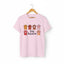 Light pink Stay Pawsitive t-shirt with colorful cat paws illustration for cat lovers.