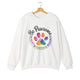 White crewneck sweatshirt featuring a colorful paw print for cat rescue advocates with text 'Be Pawsome Adopt Foster Rescue'.